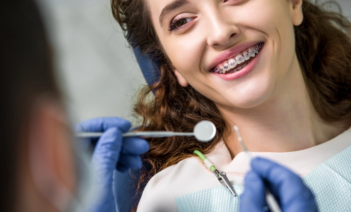 Teenager with braces receiving a dental exam