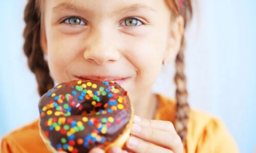 Young girl holding a donut